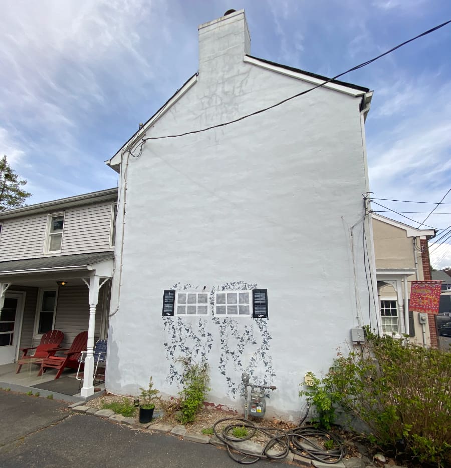 Painted trompe l'oeil window, shutters and climbing ivy on a home in Lambertville, NJ.