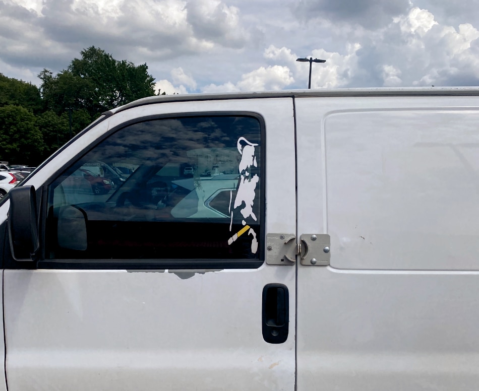 window decal of a man smoking seen in Home Depot parking lot
