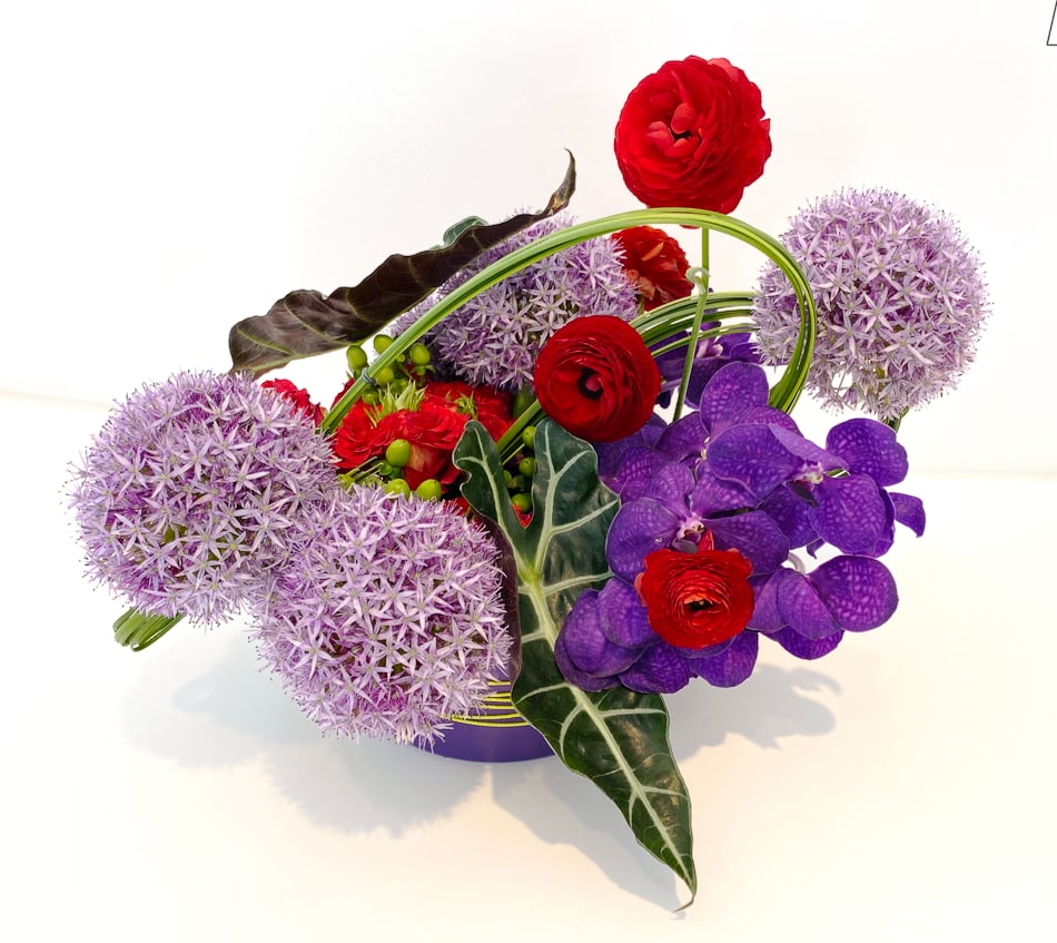 A floral arrangement with purple orchids at the Print Center New York.