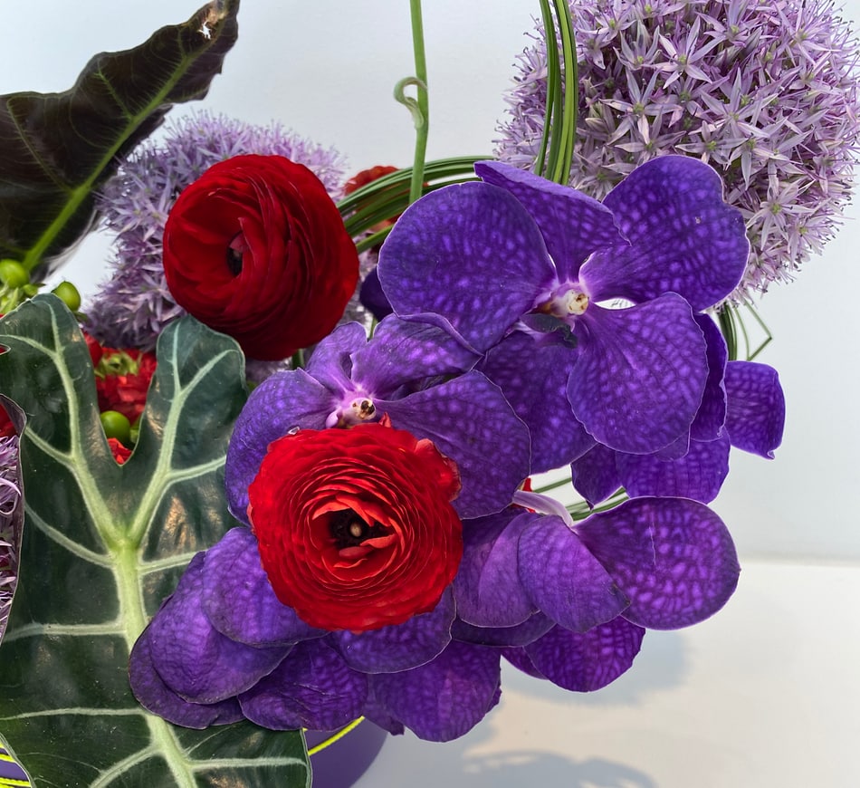 Detail of a floral arrangment with purple orchids at Print Center New York.
