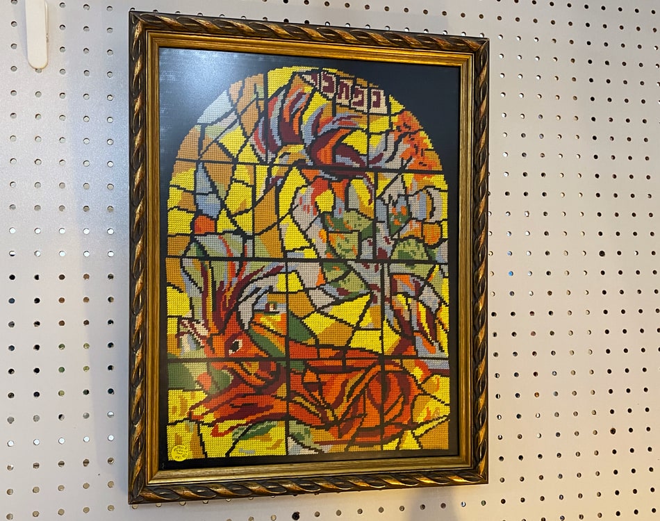 Needlepoint embroidery of deer at an antiques store