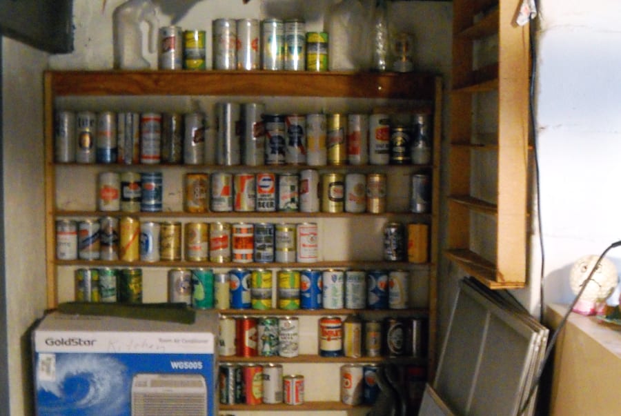 beer can collection on display shelves