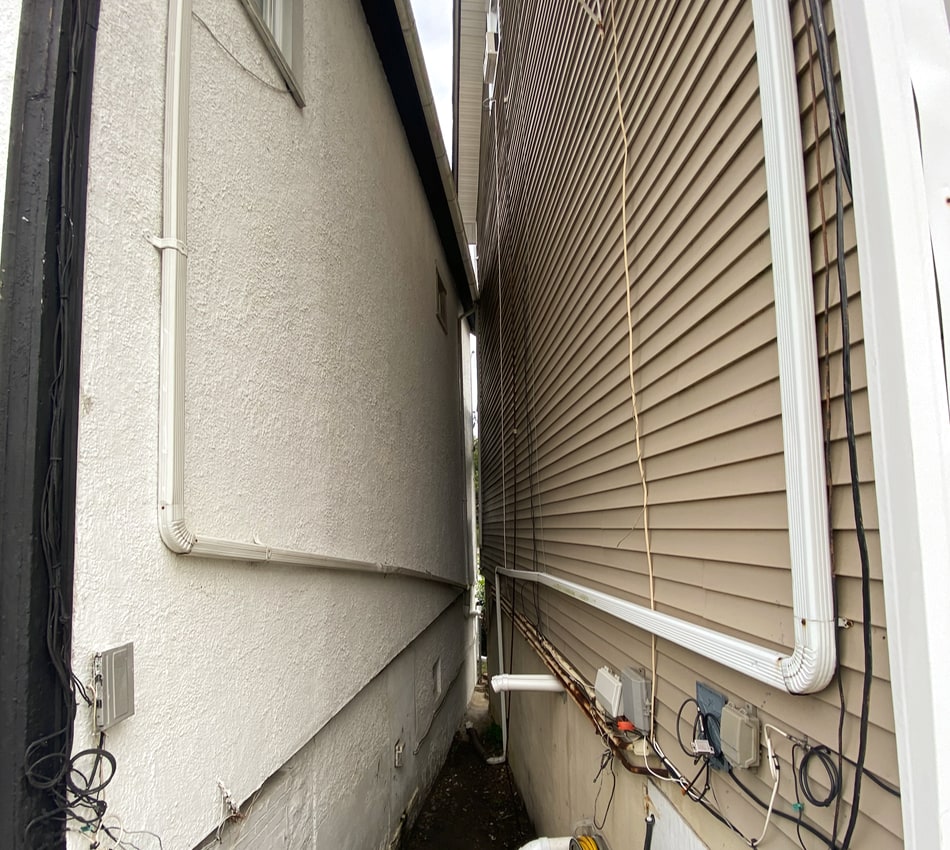 Street photography of the space between two homes in Highland Falls, NY - an example of jolie laide.
