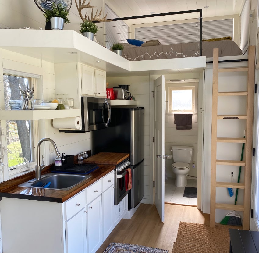 Tiny house interior showing the kitchen and bathroom