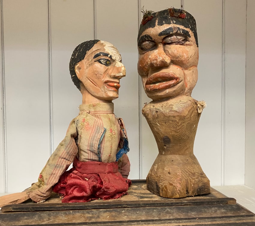 Punch and Judy wood sculptures seen in an antiques store