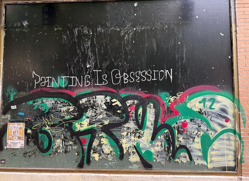 Graffiti in Madrid that says Painting is Obsession
