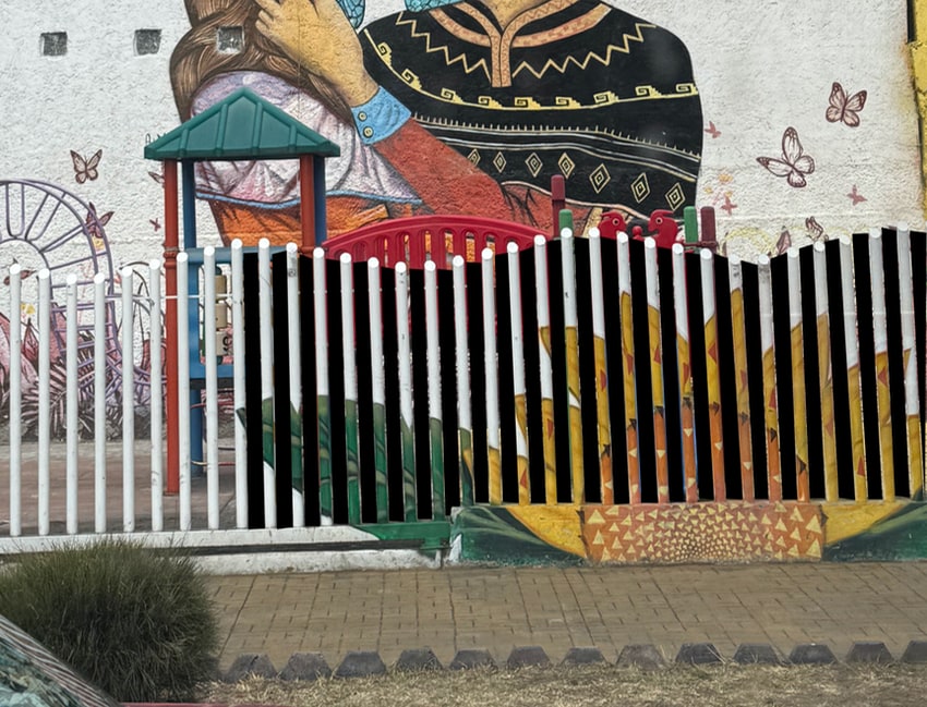 CDMX sunflower painted on a fence