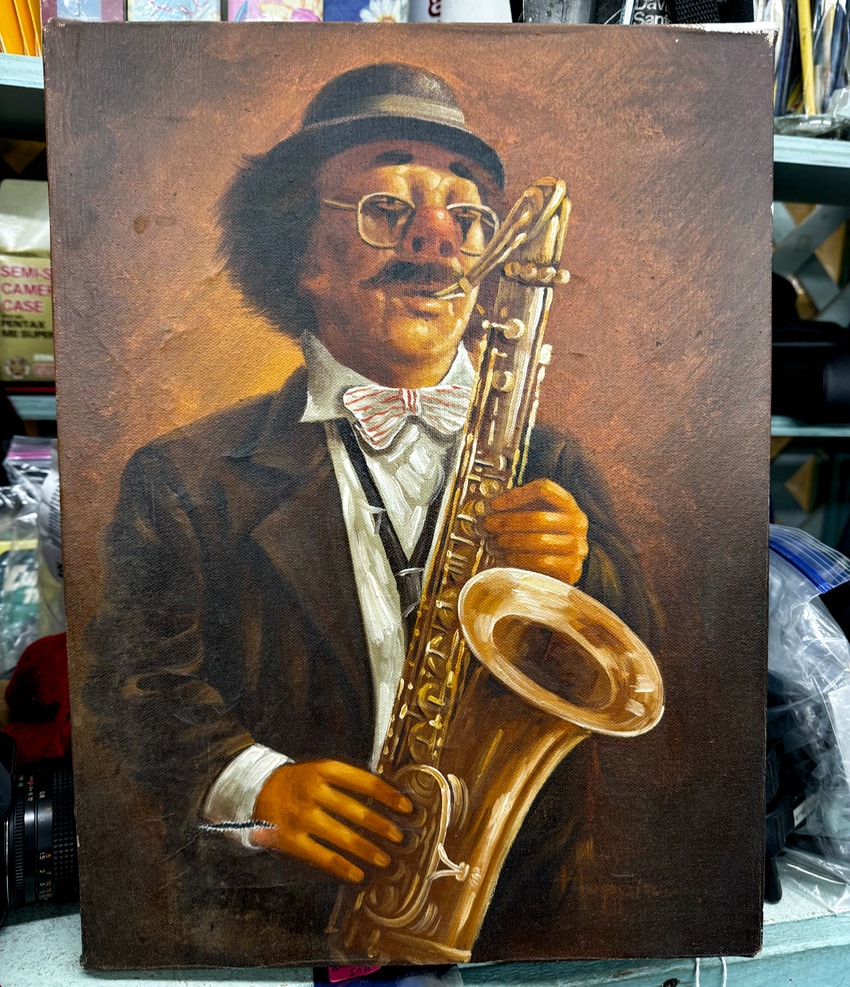 A painting of a clown playing the saxophone, seen at an antiques store in Andover, NJ