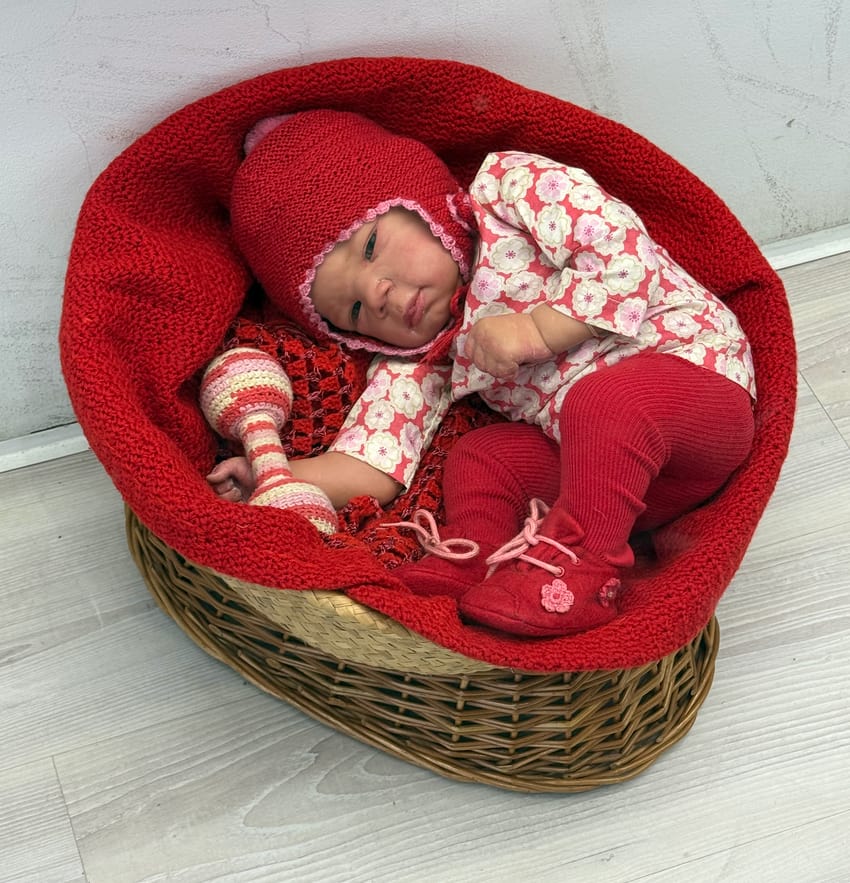 baby doll not real, in a basket in an antiques store in Barcelona