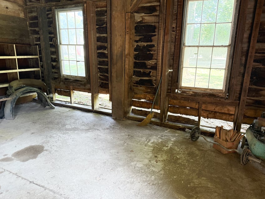 The inside of a barn in need of repair.
