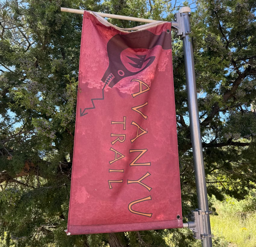 A banner for the Avanyu Trail in Santa Fe up at Museum Hill.