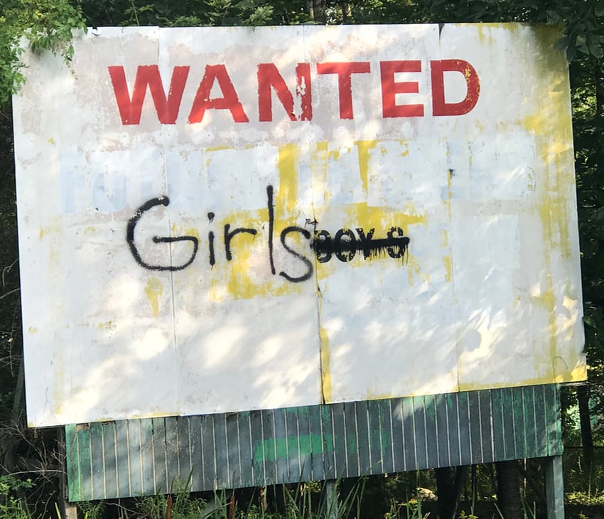 A vandalized billboard in Greenfield Park, NY, perhaps a Rotary International billboard.