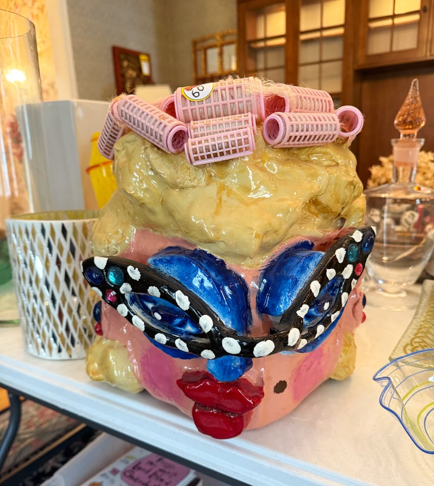 The ceramic sculpture of a woman with curlers and sunglasses as seen at the estate sale.