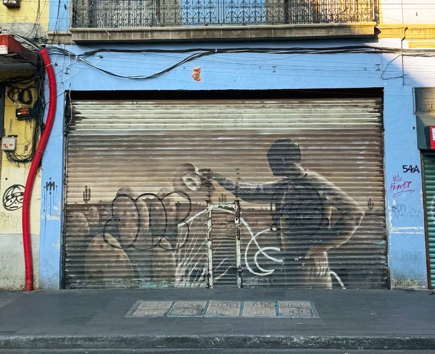 Cowboy mural on a metal gate in Mexico City