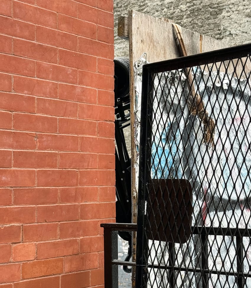 The scarf appears to hold a hidden scooter on the other side of this wall.