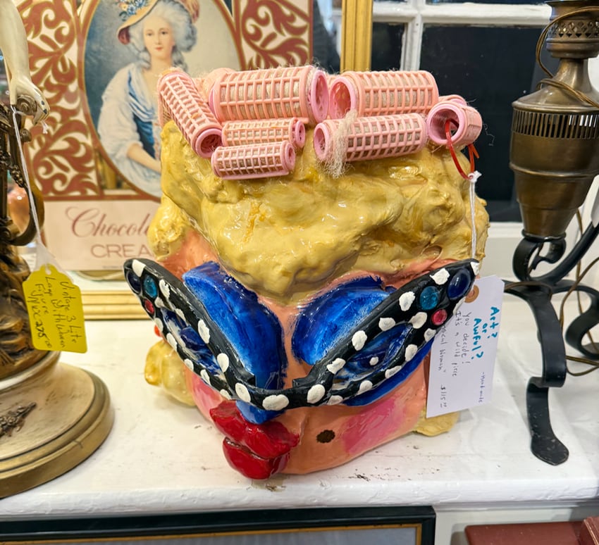kitsch art of a ceramic woman's head with curlers