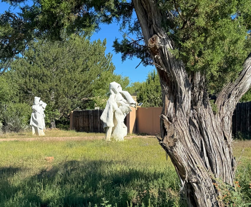 Two abstract sculptures in front of a home on the Old Santa Fe Trail.